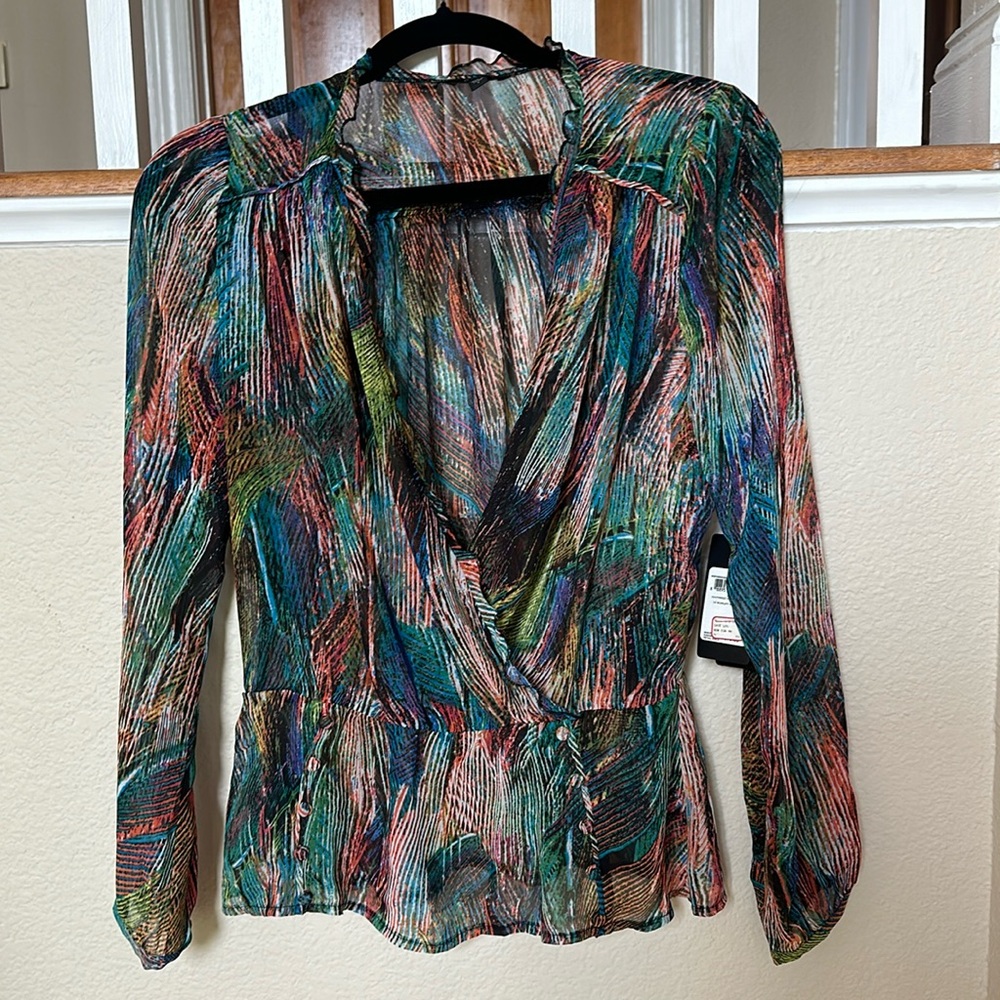 Multi colored sheer peplum long sleeve top.